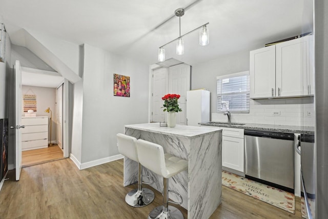 kitchen featuring light hardwood / wood-style flooring, dishwasher, white cabinetry, and a kitchen island