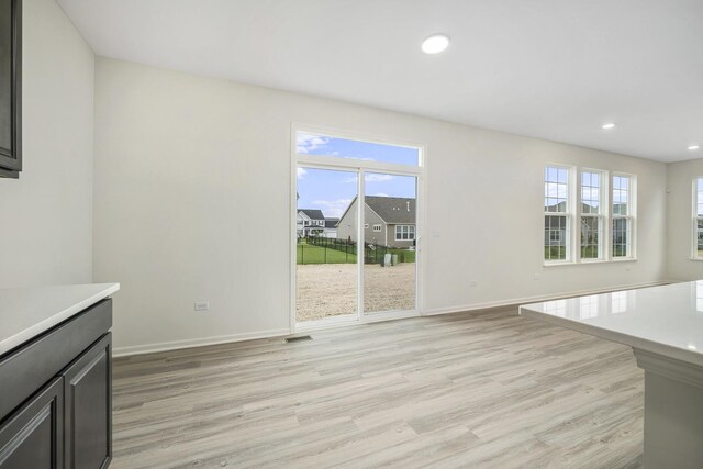 unfurnished living room featuring light wood-type flooring