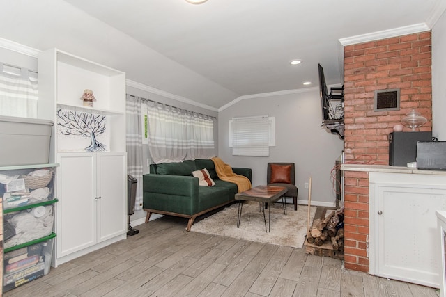 living room featuring a fireplace, light wood-type flooring, vaulted ceiling, and ornamental molding