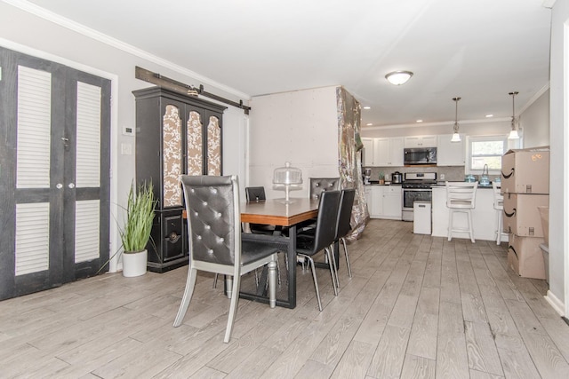 dining room featuring french doors, light hardwood / wood-style flooring, and crown molding