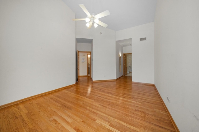 unfurnished room with light hardwood / wood-style flooring, ceiling fan, and lofted ceiling