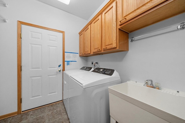 washroom featuring cabinets, sink, and washing machine and clothes dryer