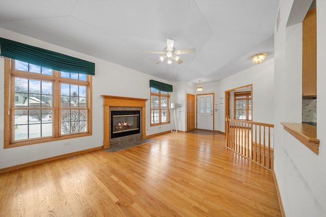 unfurnished living room with light hardwood / wood-style flooring, ceiling fan, and lofted ceiling