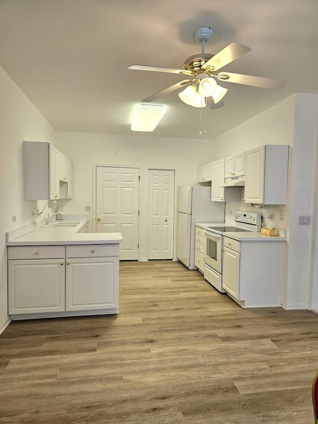 kitchen featuring sink, light hardwood / wood-style flooring, white cabinets, and white appliances