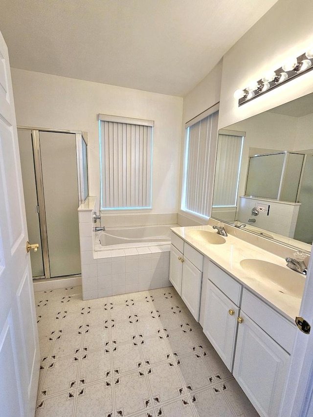 bathroom featuring vanity and shower with separate bathtub