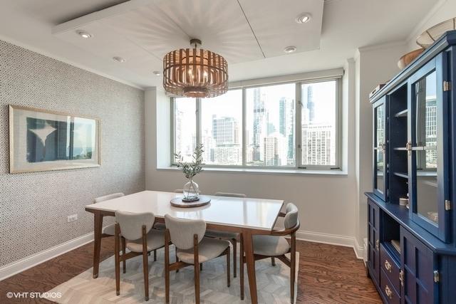 dining space with ornamental molding, a chandelier, and hardwood / wood-style floors