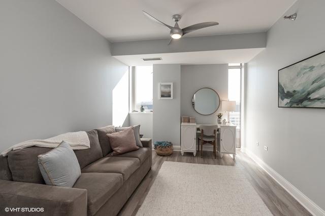 living room featuring hardwood / wood-style flooring, ceiling fan, and a healthy amount of sunlight