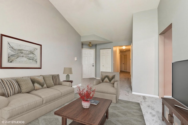 carpeted living room featuring vaulted ceiling