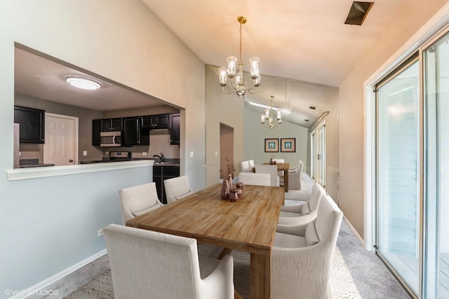 carpeted dining space with lofted ceiling, sink, and an inviting chandelier