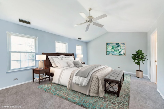 carpeted bedroom with ceiling fan and vaulted ceiling