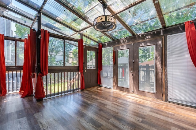 unfurnished sunroom featuring lofted ceiling and a wealth of natural light