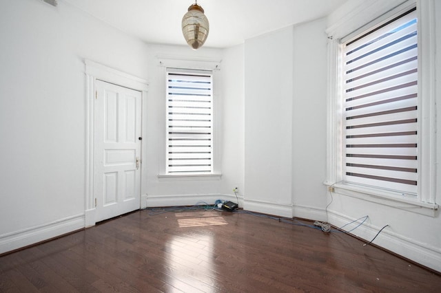 unfurnished room with dark hardwood / wood-style floors