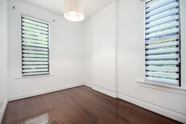 unfurnished room featuring dark hardwood / wood-style floors