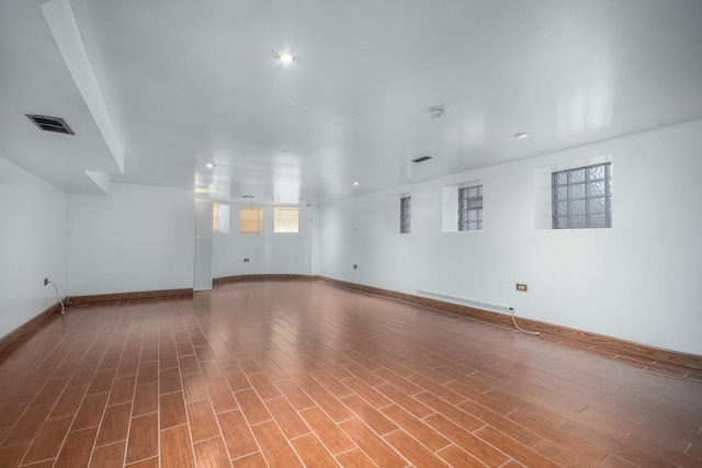 spare room featuring hardwood / wood-style flooring and baseboard heating