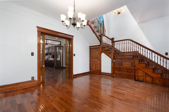 interior space with a notable chandelier and wood-type flooring