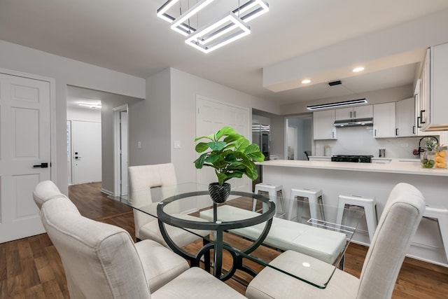 dining space featuring dark hardwood / wood-style floors and sink