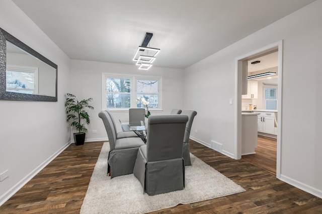 dining room with dark hardwood / wood-style floors