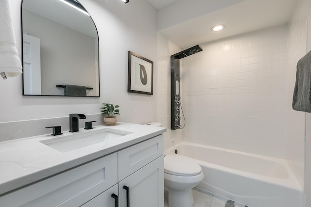 full bathroom featuring tiled shower / bath, vanity, and toilet