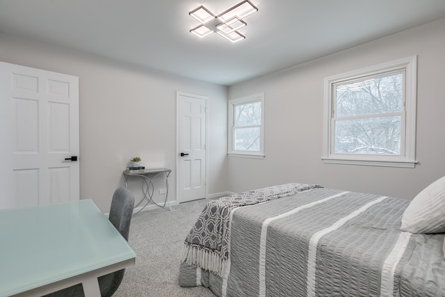 carpeted bedroom featuring multiple windows