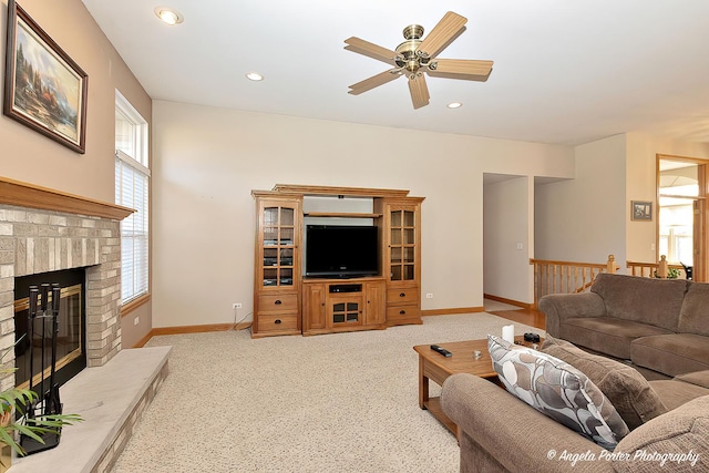 living room featuring a fireplace and ceiling fan