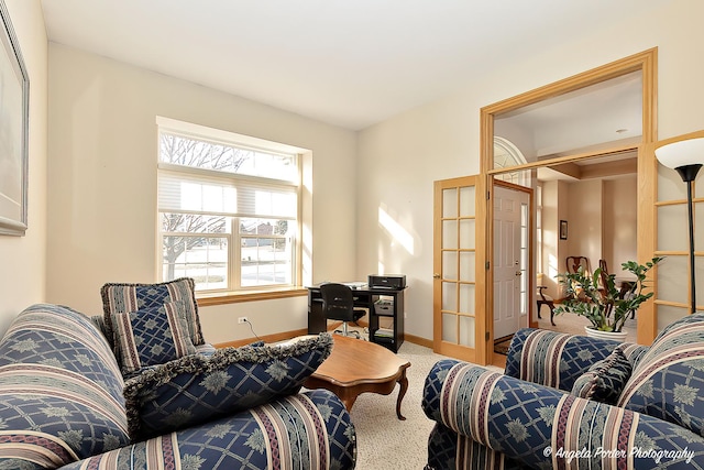 sitting room with french doors and carpet floors