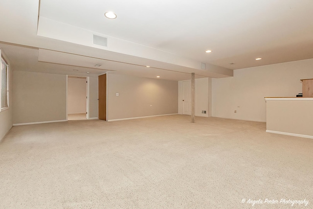 basement featuring light colored carpet