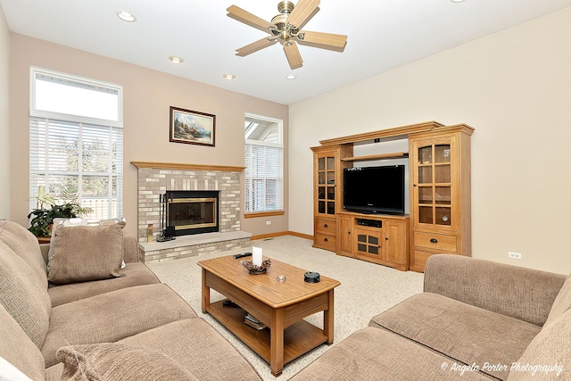 living room with light colored carpet, a brick fireplace, and ceiling fan