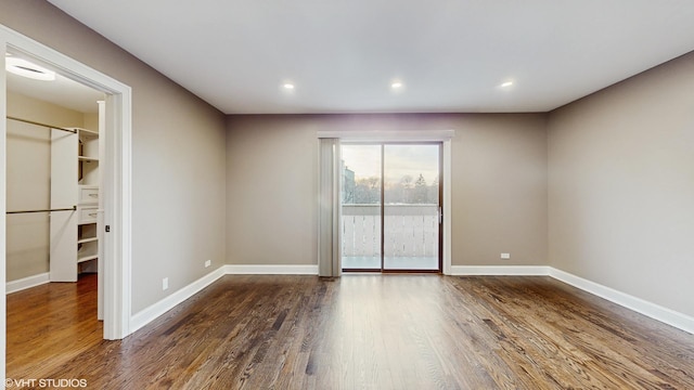 unfurnished room featuring dark wood-type flooring