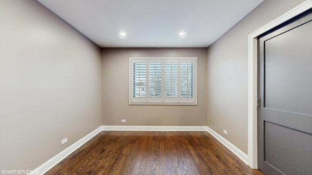 unfurnished room with dark hardwood / wood-style flooring