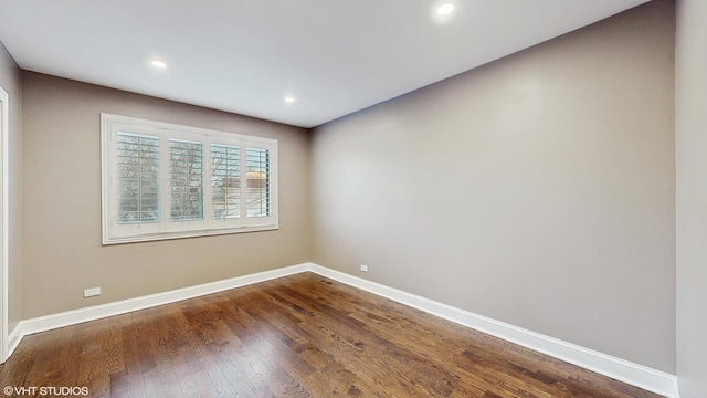 spare room featuring dark wood-type flooring