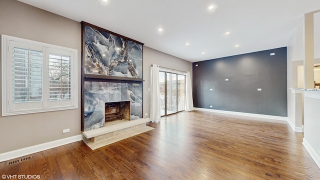 unfurnished living room with a fireplace and wood-type flooring