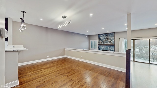 interior space with hardwood / wood-style floors and hanging light fixtures