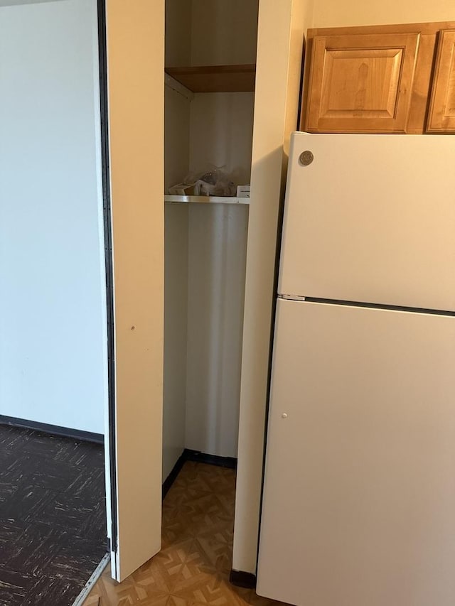 interior space with parquet flooring and white fridge