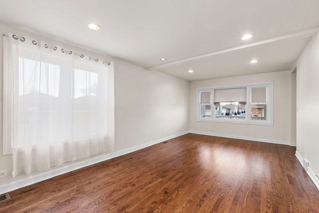 spare room with dark hardwood / wood-style floors