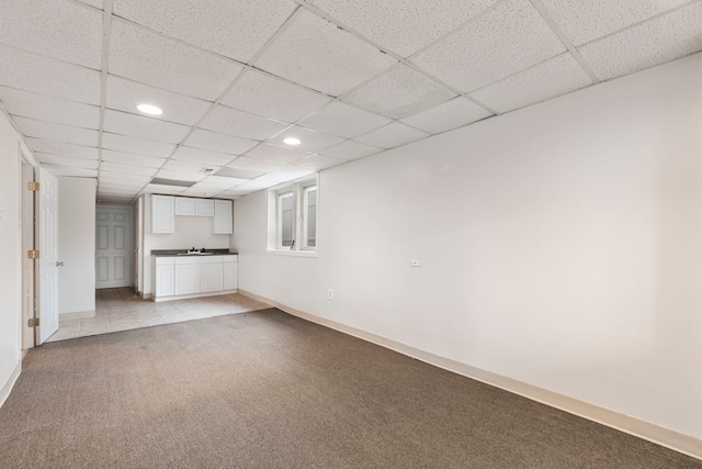 unfurnished living room featuring sink and light carpet