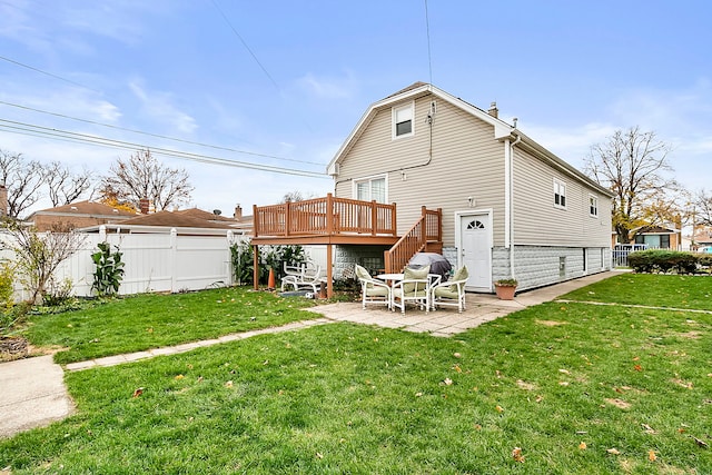 back of house with a patio area, a yard, and a wooden deck