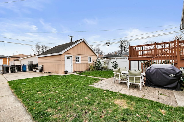 view of yard with a patio area, an outbuilding, and a wooden deck