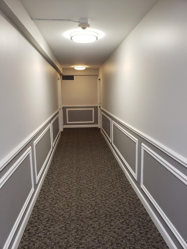 corridor with dark colored carpet