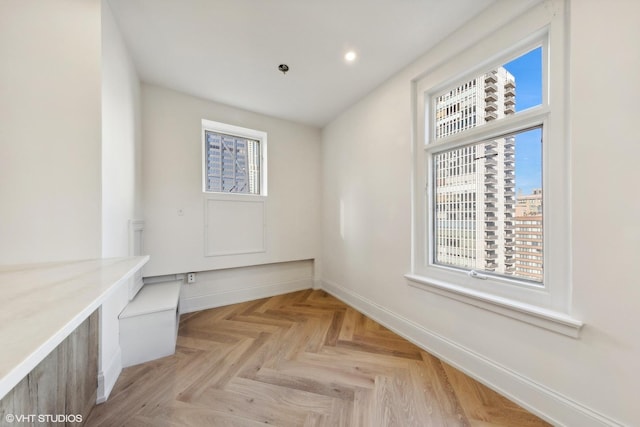 interior space featuring plenty of natural light and light parquet flooring