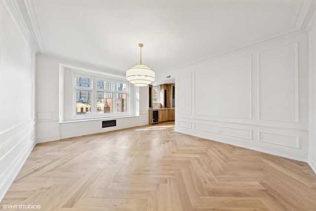 unfurnished living room with light parquet floors and ornamental molding