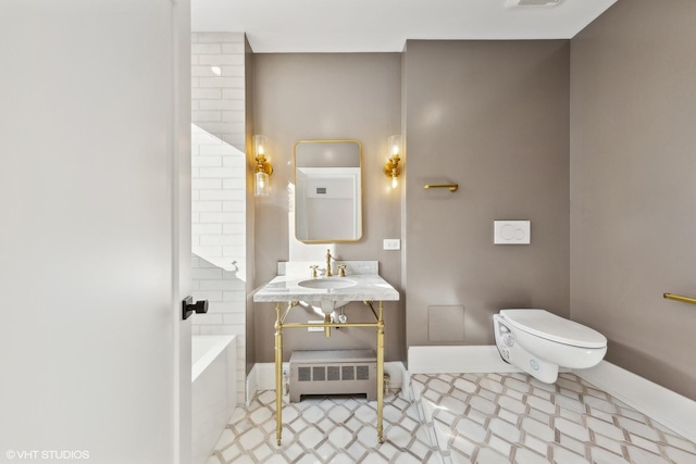 bathroom featuring a bathing tub, vanity, and toilet