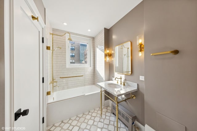 bathroom with tiled shower / bath combo and sink