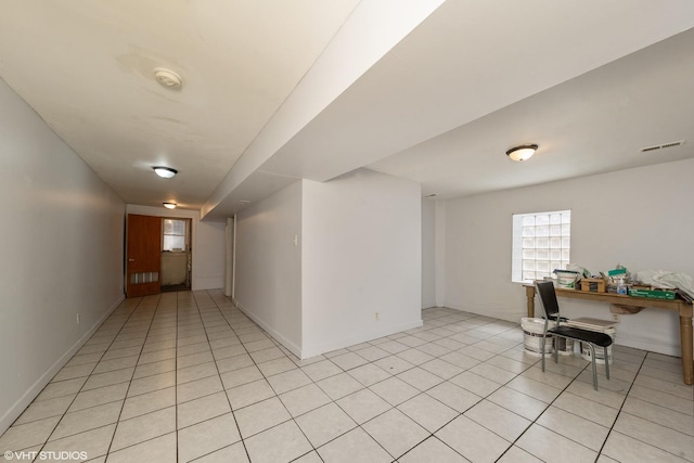 hall with light tile patterned floors