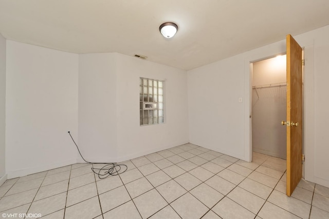 unfurnished bedroom with a closet and a spacious closet