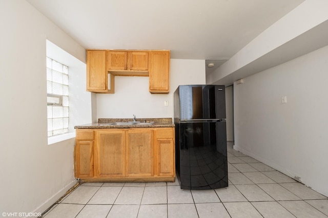 kitchen with sink and black refrigerator