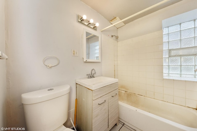 full bathroom with toilet, vanity, and tiled shower / bath combo