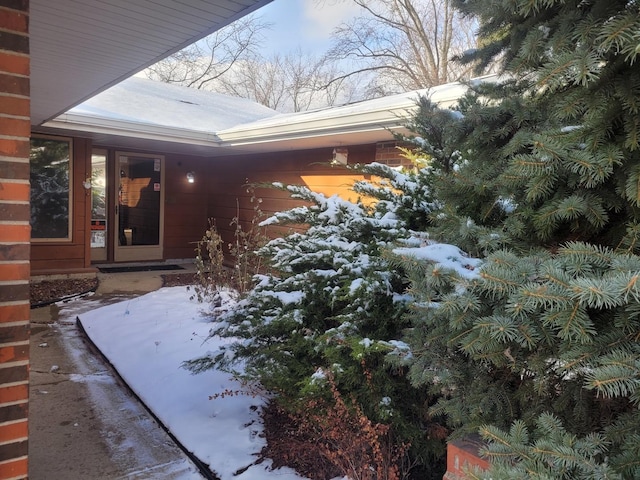 view of snow covered property entrance