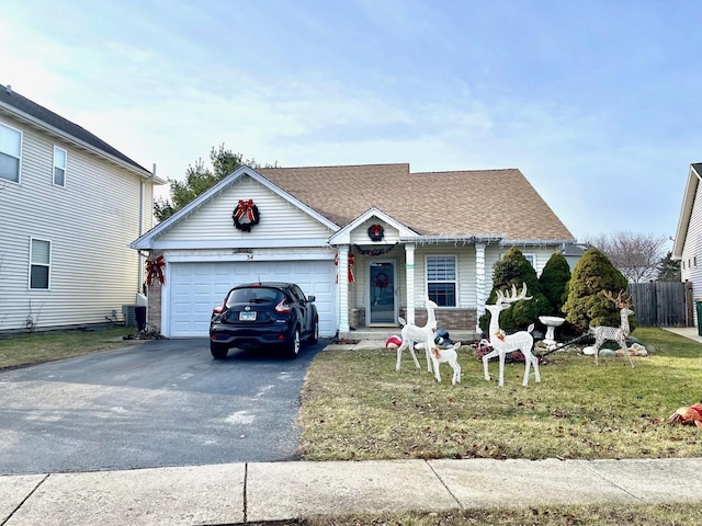 view of front of house featuring a front yard, a garage, and cooling unit