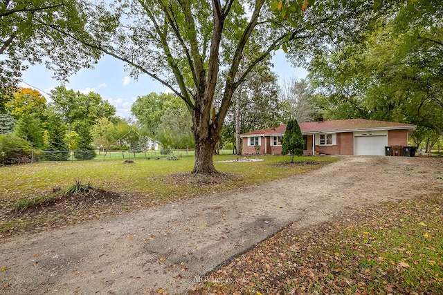 view of front of property with a front yard and a garage