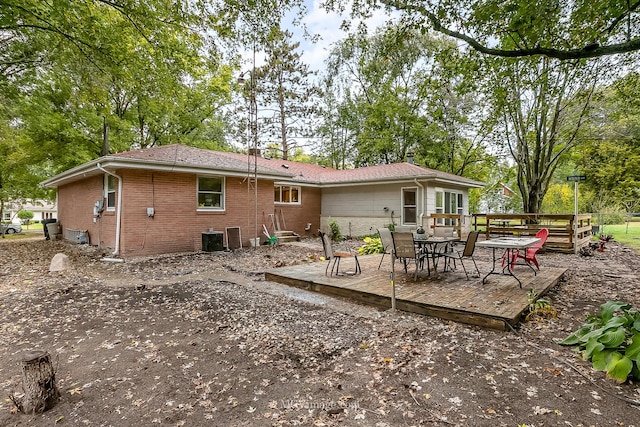 back of house featuring a wooden deck and central AC